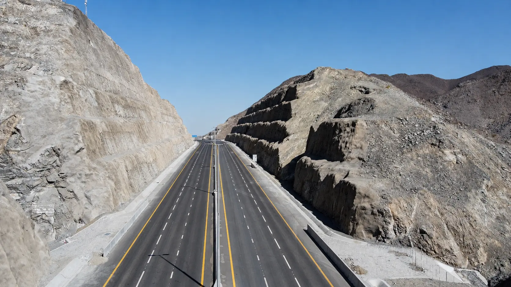 Engineered multi-lane Al Watan Road corridor flanked by high benched mountain rock cuts